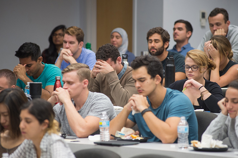 Students practicing mindfulness at stress management seminar
