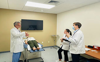 patient with doctor and students
